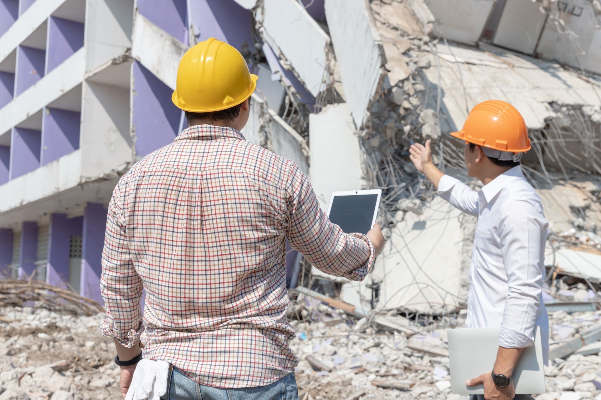 Engineer architect and worker operation control demolish old building.